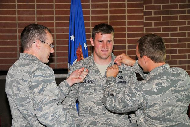 First Lt. Joseph Achenbach (center) is pinned by 1st Lt. Benjamin Hoff (left) and 1st Lt. Chance Johnson at a promotion ceremony. (U.S. Air Force/Jacqueline Cowan)