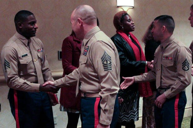 Marines congratulate Sgt. DeMonte R. Cheeley (far left) on receiving the Purple Heart Medal at a Jan. 26, 2016 ceremony, for injuries from a July 2015 attack at the Armed Forces Career Center in Chattanooga, Tenn. (US Marine Corps photo/Diamond Peden)