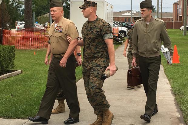 Marine Col. Daniel Hunter Wilson is escorted into a court-martial proceeding on Aug. 30, 2017, aboard Camp Lejeune, N.C. Photo by Hope Hodge Seck/Military.com