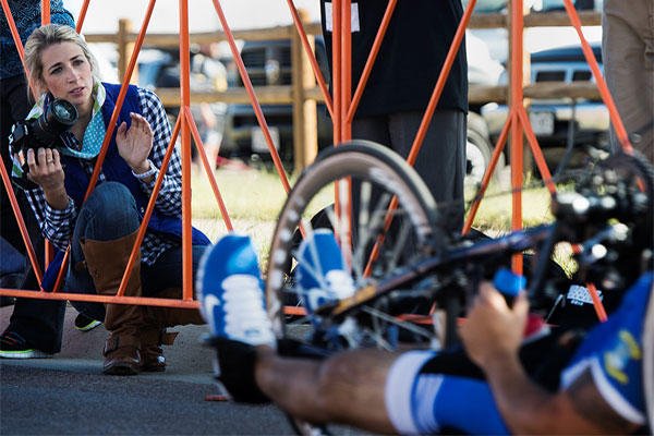 Ashley Means watches for her husband Jeremiah at the finish line of the Warrior Games cycling event Sept. 29, 2014, at Fort Carson, Colo. Senior Airman Jette Carr/Air Force