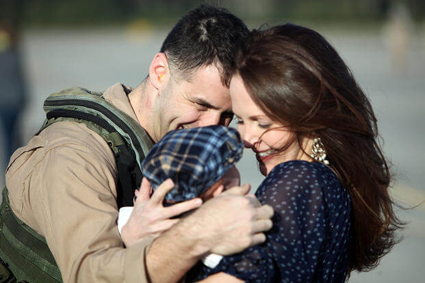 A Marine with Fighter Attack Squadron 251 is reunited with his family. (Photo: U.S. Marine Corps/Lance Cpl. Timothy Norris.)