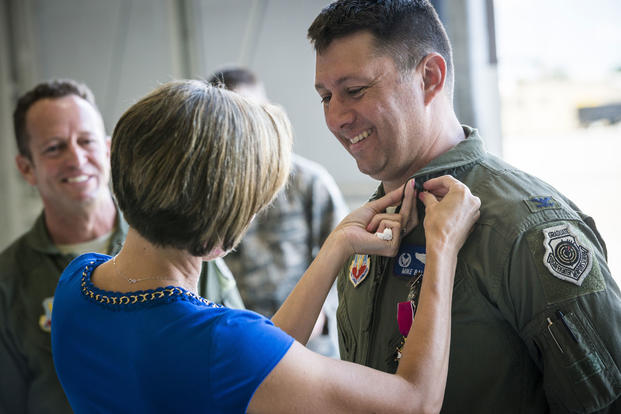 Veronica Ballek, wife of Col. Michael Ballek, pins a retirement pin on her husband during his retirement ceremony at Mountain Home Air Force Base, Idaho, June 2, 2015. Tech. Sgt. Samuel Morse/Air Force