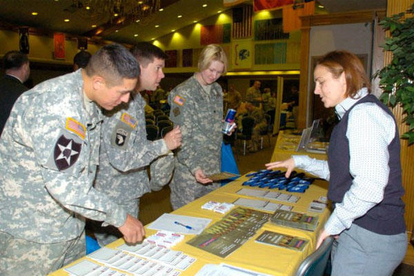 3 soldiers at job fair table