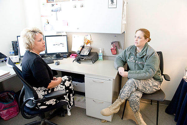 Cynthia Basham, a registered nurse case manager with the Fort Hood Warrior Transition Brigade, speaks with Staff Sgt. Christine Einig-Blackwell, a WTB squad leader. (U.S. Army photo)