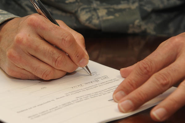 Service member signing a contract