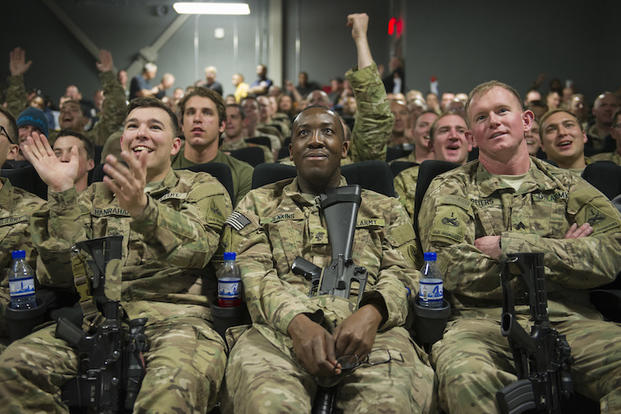 Service members deployed to Bagram Air Field, Afghanistan, clap and cheer as they prepare to view first showing of Star Wars: The Force Awakens, here, Dec. 22, 2015. The Army & Air Force Exchange Service partnered with Walt Disney Studios to give service members a chance to see the movie in a deployed location. (U.S. Air Force photo by Tech. Sgt. Robert Cloys)