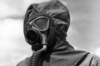FILE -- Close-up of a soldier in gas mask and protective cloth permeable helmet at Chemical Warfare decontamination demonstration at Fort Bliss, Tx. (Sept. 7, 1944) (Signal Corps Photo via Center of Military History)