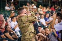 A soldier surprises his family after a year long deployment at an Arizona Diamondbacks game in Phoenix Arizona in 2017. (U.S. Air Force/Jensen Stidham)