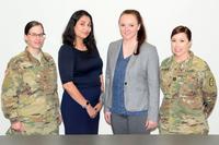 U.S. Army Cpl. Samantha Williams, a paralegal, Aracely Lopez and Evelyn Saxton, both lawyers, and U.S. Army Capt. Katie Reynolds, the site coordinator, pose at the North Carolina National Guard Headquarters Judge Advocate courtroom at NCNG headquarters in Raleigh, North Carolina, May, 3, 2019. The team of legal experts through the IRS Volunteer Income Tax Assistance program prepared and filed more than 550 state and federal tax returns from January to April this year for service members, retirees and their