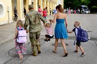 A military family walks to the Aviano Elementary School at Aviano Air Base, Italy.