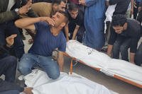 Mourners carry the bodies of members of the Abu Taha family who were killed in an Israeli airstrike