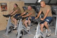 Seabees ride stationary bikes for cardio exercise in the gym at Camp Natasha, Afghanistan.
