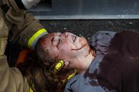 Marine Corps firefighter tends to a simulated victim at a crisis response drill
