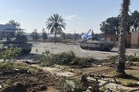 a tank with an Israel flag on it entering the Gazan side of the Rafah border crossing