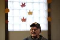 Earl Meyer, who fought for the U.S. Army in the Korean War, talks with fellow veterans at the American Legion
