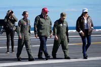 President Donald Trump and first lady Melania Trump walk on the flight deck as part of the Navy's 250th anniversary celebration, aboard the USS George H.W. Bush aircraft carrier in the Atlantic Ocean off the coast of Norfolk, Va., Sunday, Oct. 5, 2025. (AP Photo/Alex Brandon) Trump Navy