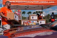 A volunteer carries a box of donated groceries to a car during a food distribution to assist federal employees during the government shutdown, organized by the local leadership of the American Federation of Government Employees union in conjunction with Feeding South Florida, Tuesday, Oct. 28, 2025, in Dania Beach, Fla. (AP Photo/Rebecca Blackwell) A volunteer carries a box of donated groceries to a car during a food distribution to assist federal employees during the government shutdown, organized by the local leadership of the American Federation of Government Employees union in conjunction with Feeding South Florida, Tuesday, Oct. 28, 2025, in Dania Beach, Fla. (AP Photo/Rebecca Blackwell)