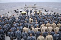 Sailors and Marines on the USS Green Bay during an all-hands call