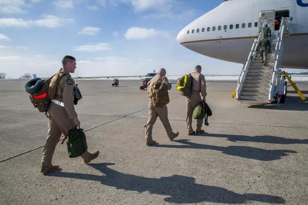 Minot Airmen board a plane during a mass deployment at Minot Air Force Base, N.D., March 9, 2017. (U.S. Air Force/Senior Airman Christian Sullivan)