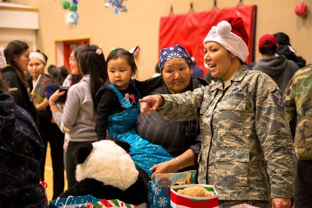 Alaska National Guard members and volunteers visit with children of St. Michael, Alaska, during Operation Santa Claus Dec. 5, 2017. (U.S. Army National Guard/Marisa Lindsay) 