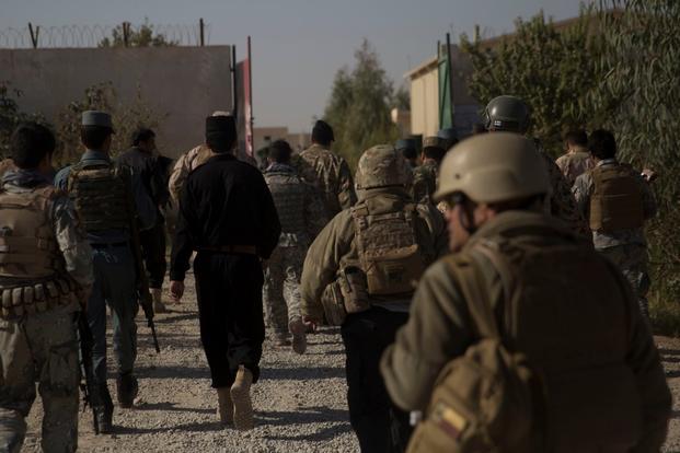 U.S. Marine advisors with Task Force Southwest and advisors with Resolute Support walk through the Regional Training Center compound to begin their assessment and evaluations in Lashkar Gah, Afghanistan, Nov. 15, 2017. (U.S. Marine Corps photo)