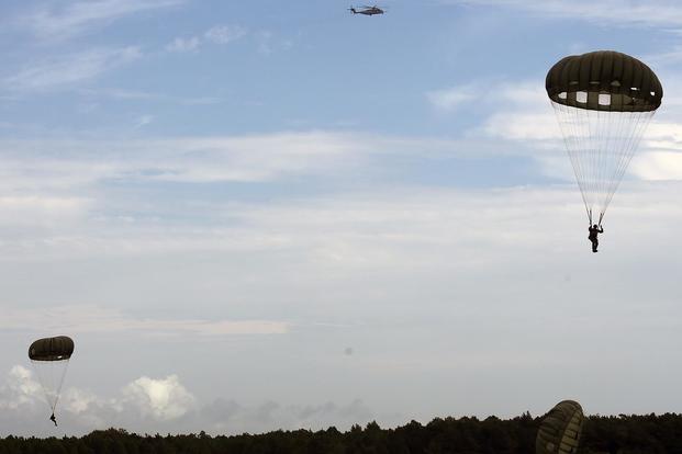 Marines assigned to 2nd Raider Battalion, Marine Corps Forces Special Operations Command, parachute from a CH-53E Super Stallion during a static line parachute training exercise near Marine Corps Air Station New River, N.C., on July 28, 2017. Lance Cpl. Justin Roux/Marine Corps