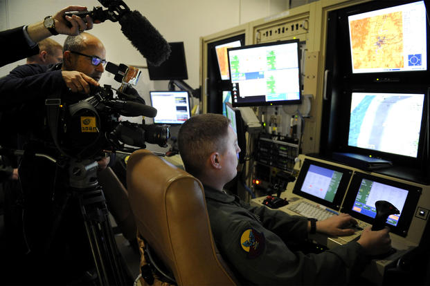 Media outlets film an Air Force sensor operator inside the 16th Training Squadron MQ-1/MQ-9 simulator at Holloman Air Force Base, New Mexico. (US Air Force photo/Carolyn Herrick)