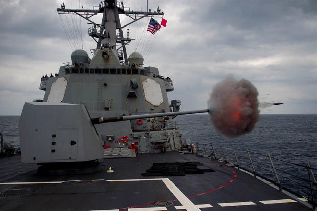 The destroyer USS Mustin fires its 5-inch gun during a live fire exercise in waters off Japan in January 2015. Last week, the warship sailed near disputed territory claimed by China. (US Navy photo/Christian Senyk)