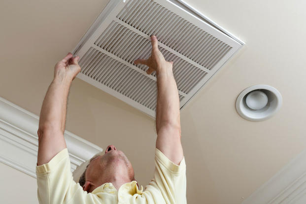 Man inspecting HVAC vent