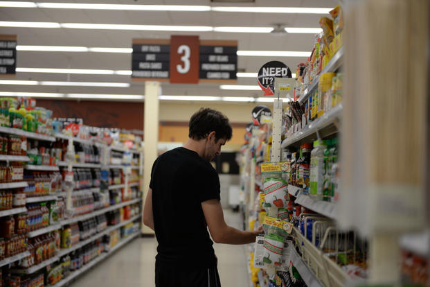 A customer at the base Commissary looks at food items July 13, 2017, on Columbus Air Force Base, Mississippi. (U.S. Air Force photo/Keith Holcomb)