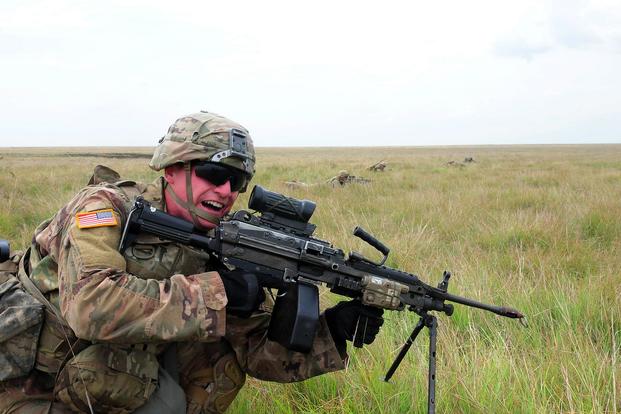 A Soldier assigned to B Co., 2nd Battalion, 5th Cavalry Regiment, 1st Armored Brigade Combat Team, 1st Cavalry Division with a M249 light machine gun charges forward during small arms training at Smardan Training Area, Romania, July 5, 2018. (U.S Army/ Sgt. 1st Class Robert Jordan)