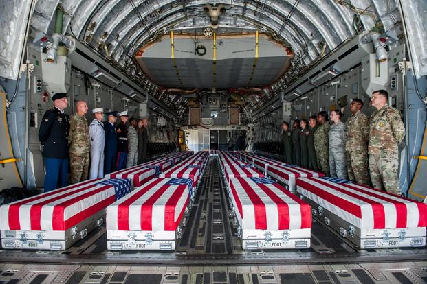 Transfer cases, containing the remains of what are believed to be U.S. service members lost in the Korean War, line the bay of a U.S. Air Force C-17 Globemaster III aircraft during an honorable carry ceremony at Joint Base Pearl Harbor-Hickam, Hawaii, Aug. 1, 2018.. (U.S. Air Force/Senior Airman Apryl Hall)