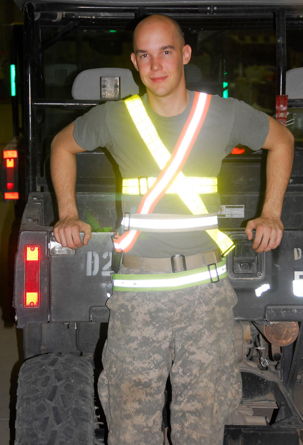 Sgt. Jason Guge of Billings, Mont., a Black Hawk helicopter mechanic, wears several physical training belts in a hanger at Contingency Operating Base Adder, Iraq in 2009. (U.S. Army)