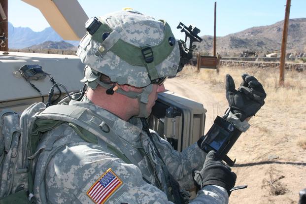 Staff Sgt. Reag Wood of 1st Combined Arms Battalion, 5th Brigade, 1st Armored Division, illustrates how he uses an iphone to obtain a visual image of a mock with insurgent activity during a field training exercise at White Sands Missile Range, N.M. (U.S. Army/Lt. Col. Deanna Bague)