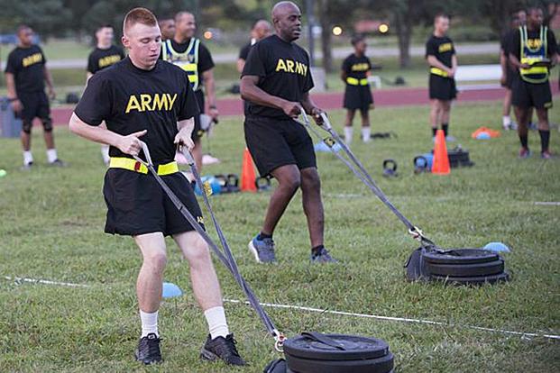 Pfc. Alex Colliver, foreground, pulls a 90-pound sled 50 meters to simulate the strength needed in pulling a battle buddy out of harm's way during a pilot test of the Army Combat Fitness Test, a six-event assessment designed to reduce injuries and replace the current Army Physical Fitness Test. (Photo by Sean Kimmons)