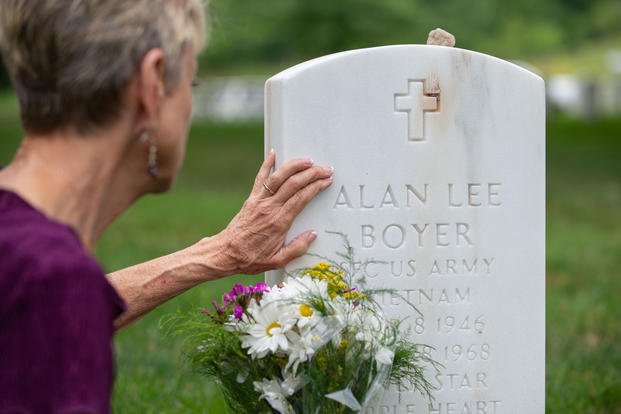 Judi Boyer-Bouchard touches the headstone for her brother, Sgt. 1st Class Alan Boyer, during a visit to Arlington National Cemetery, Va., June 20, 2018. (U.S. Army photo/Sean Kimmons)
