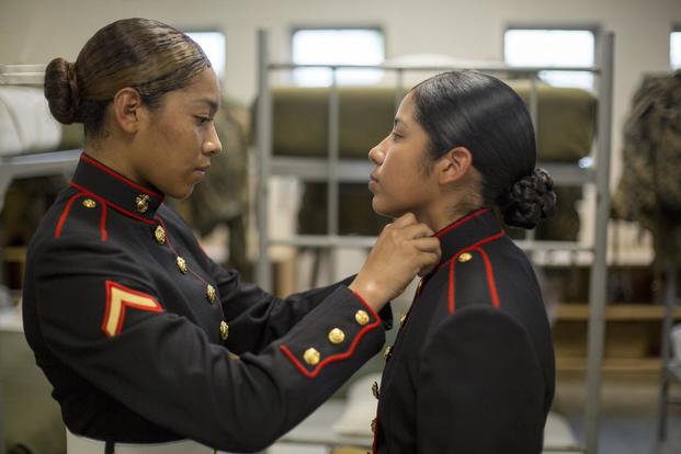 Pfc. Kathy Espinoza, from New York City, N.Y. inspects the new dress uniform of Pvt. Arella Aleman, from Dallas, Texas Nov. 9, 2018 at Marine Corps Recruit Depot Parris Island, S.C. (U.S. Marine Corps/Staff Sgt. Tyler Hlavac)