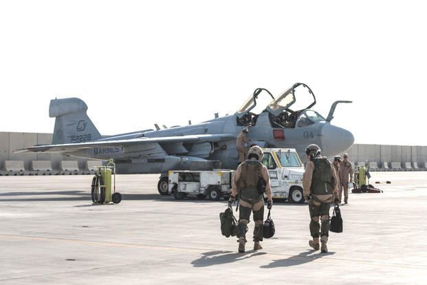  Marines deployed with Marine Tactical Electronic Warfare Squadron 2 walk to their EA-6B Prowler at Al Udeid Air Base, Qatar on Sept. 12. VMAQ-2 has completed its final deployment, and the last six Prowlers in the U.S. military's inventory are being retired. (US Air Force photo/Ted Nichols)