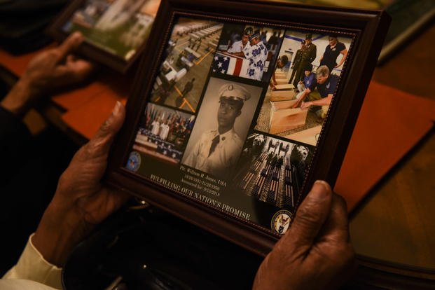 Ida Jones-Dickens holds a collage at her sister’s home in Rocky Mount, North Carolina, Nov. 15, 2018. (U.S. Air Force photo by Staff Sgt. Apryl Hall)