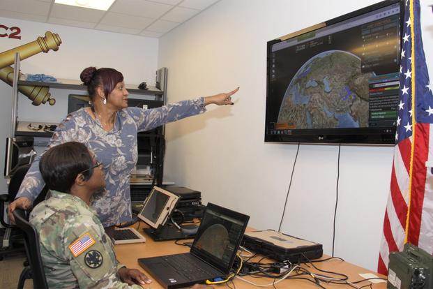 Capt. Tawanda Baxter and Flora Marshall, of Army Project Manager Mission Command, demonstrate the Tactical Interface Tracking Application Node at Aberdeen Proving Ground, Maryland, on Dec. 4, 2018. (U.S. Army/Dan Lafontaine)