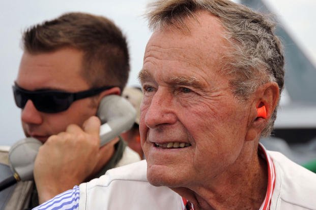 Former President George H.W. Bush watches flight operations from the landing signal officer's platform aboard the aircraft carrier that bears his name, USS George H.W. Bush. (U.S. Navy)