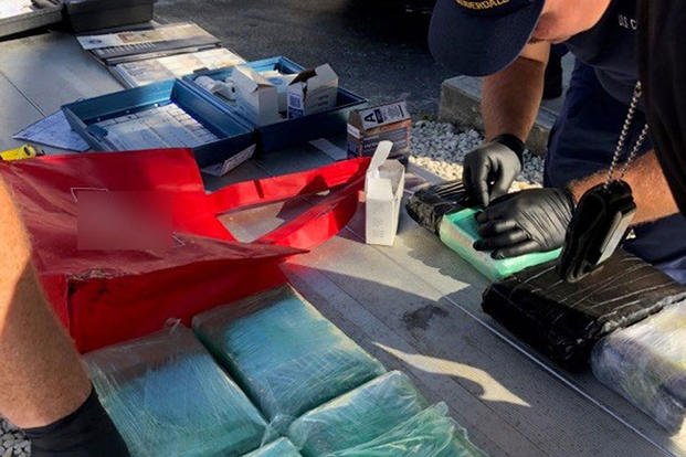 A Coast Guard Bernard C. Webber (WPC-1101) crewmember conducts a narcotics identification kit test on seized cocaine at Coast Guard Station Fort Lauderdale, Jan. 7, 2019. (U.S. Coast Guard photo)