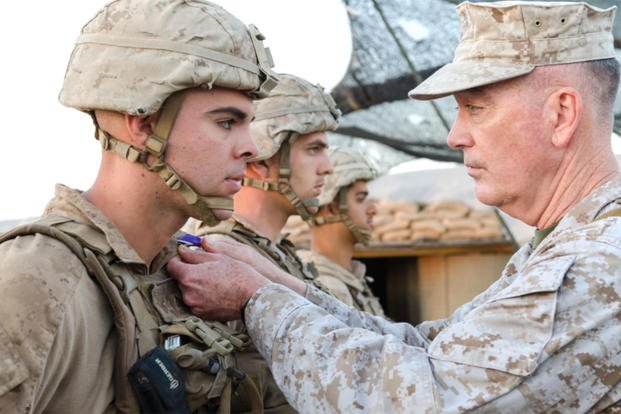 April 22, 2016: Gen. Joseph Dunford presents a U.S. Marine with the Purple Heart during a ceremony at Kara Soar Base in Makhmur, Iraq. Veterans wounded in World War I later became eligible to receive the Purple Heart, which wasn't officially designated until 1932. (US Army photo/Peter J. Berardi) 