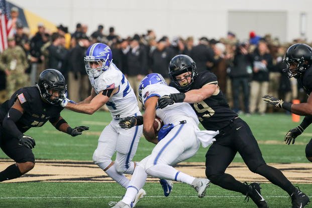 An Army Black Knights football player tackles an Air Force Falcons player at Michie Stadium in West Point, N.Y., Nov. 3, 2018. (U.S. Army photo by Brandon OConnor)