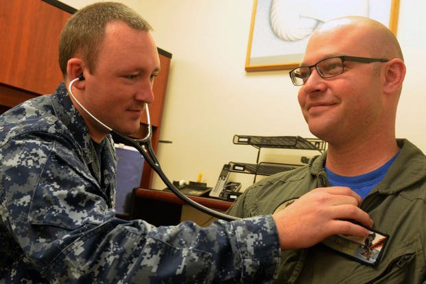 Hospital Corpsman 2nd Class Scott Henry monitors Naval Aircrewman Mechanical 1st Class David Gilbert’s heart at Naval Hospital Jacksonville’s Urology Clinic. (U.S. Navy/Jacob Sippel)