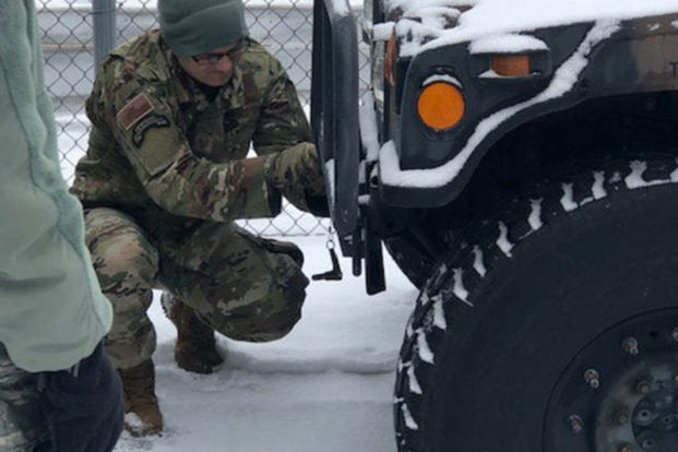 New York Air National Guard Master Sgt. Peyton Knippel, assigned to the 174th Attack Wing, prepares a Humvee for a snow storm response mission at Hancock Field Air National Guard Base in Syracuse, N.Y. on Jan. 18. The New York National Guard alerted 450 airmen and soldiers for possible missions as a major snow storm approaches New York. (Air National Guard photo/Barbara Olney)