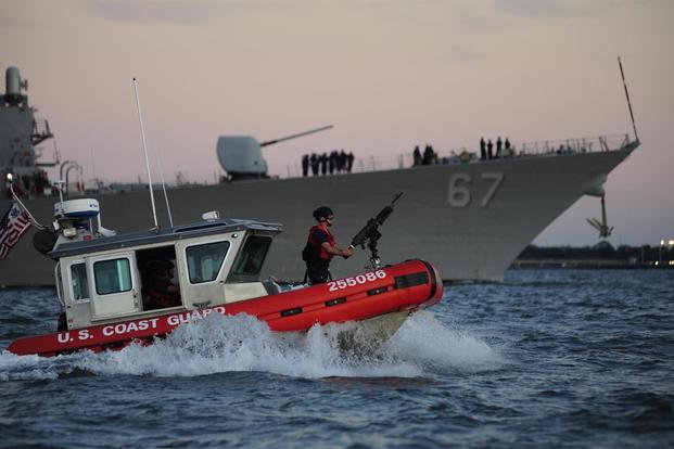 A Coast Guard Maritime Safety and Security Team crew, temporarily deployed from San Francisco, provides an escort for the USS Cole as the Navy destroyer returns to the Norfolk Naval Shipyard. (U.S Coast Guard/Petty Officer 3rd Class David Weydert)