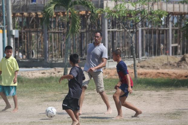 Cmdr. Jeremy Butler, center, commanding officer, Expeditionary Port Unit 113 and Navy reserve component sailor, plays a game of soccer with kids of the Protection and Development Center during a Cobra Gold 2017 community outreach event. EPU 113 is a reserve unit based out of Fort Worth, Texas. (Grady T. Fontana/U.S. Navy)
