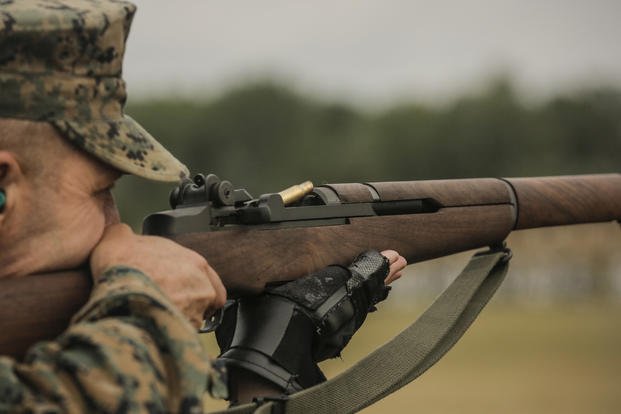 U.S. Marine Corps Col. Randall Hoffman, Commanding Officer of MCRD Parris Island Weapons and Field Training Battalion, Fires the M1 Garand rifle during the Hearst Doubles Match at Camp Perry Ohio July 31, 2018. (Yamil Cassareal/Marine Corps)