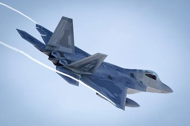 An F-22 Raptor takes off after Raptors from the 3rd Wing and 477th Fighter Group participated in a close formation taxi, known as an Elephant Walk, March 26, 2019, during a Polar Force exercise at Joint Base Elmendorf-Richardson, Alaska. (U.S. Air Force photo/Justin Connaher)
